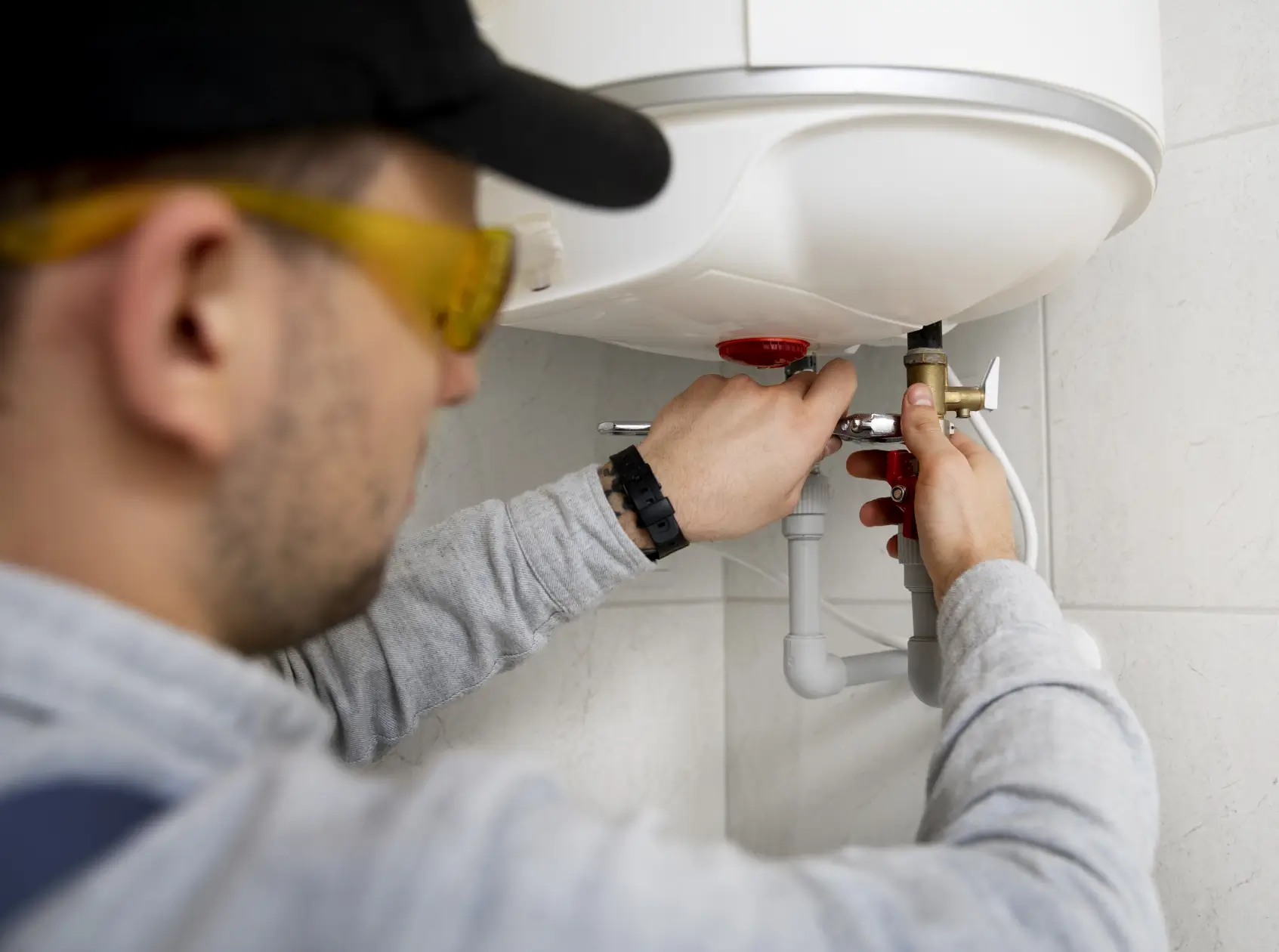 Professional plumber replacing water heater in Dubai